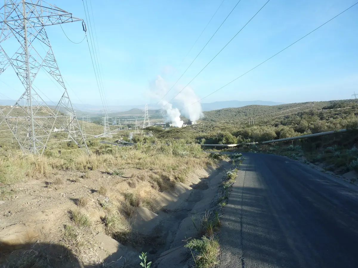 White geothermal steam plumes and power lines above a road in Hell's Gate