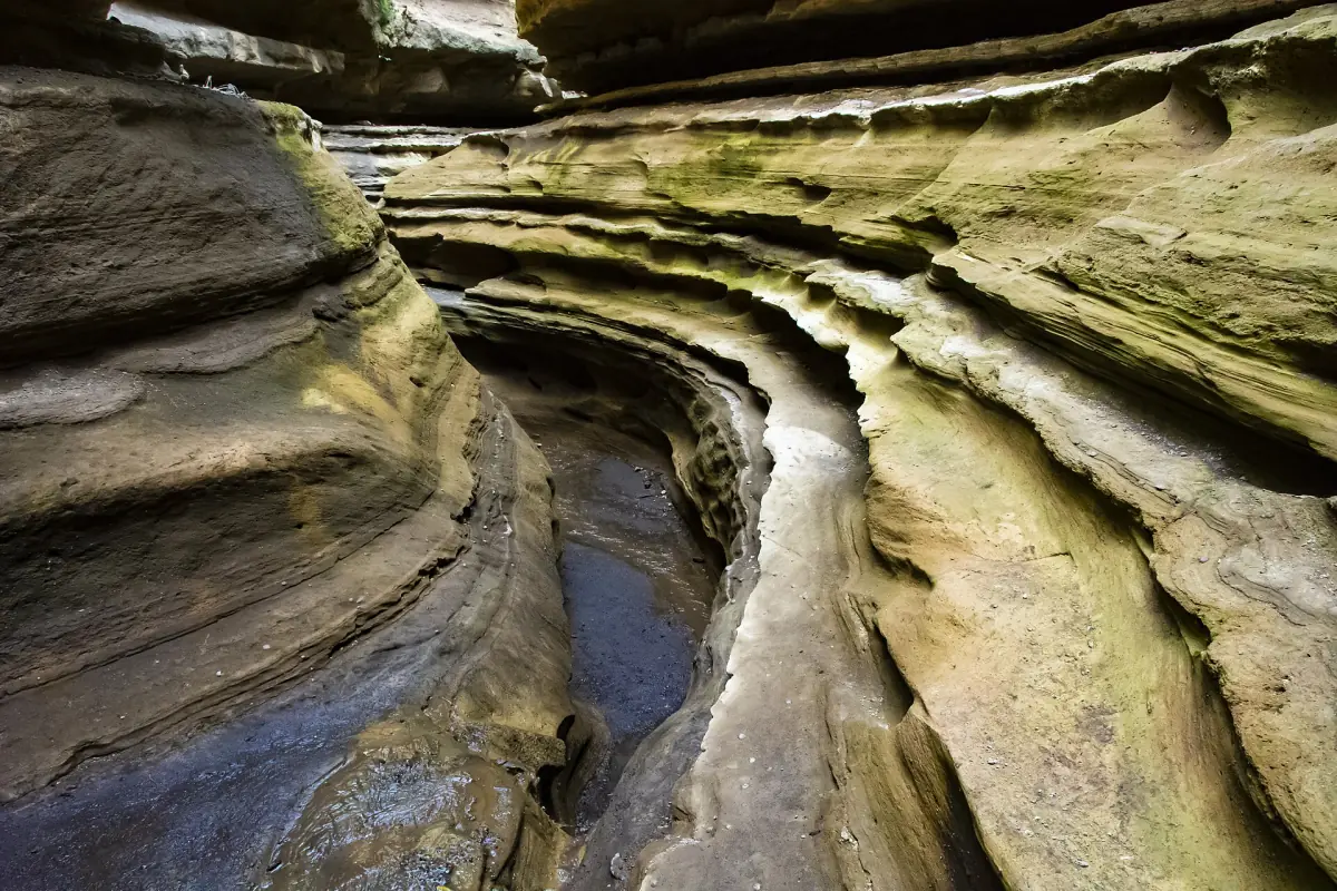 Narrow water channel cut through layered rock in the Ol Njorowa Gorge