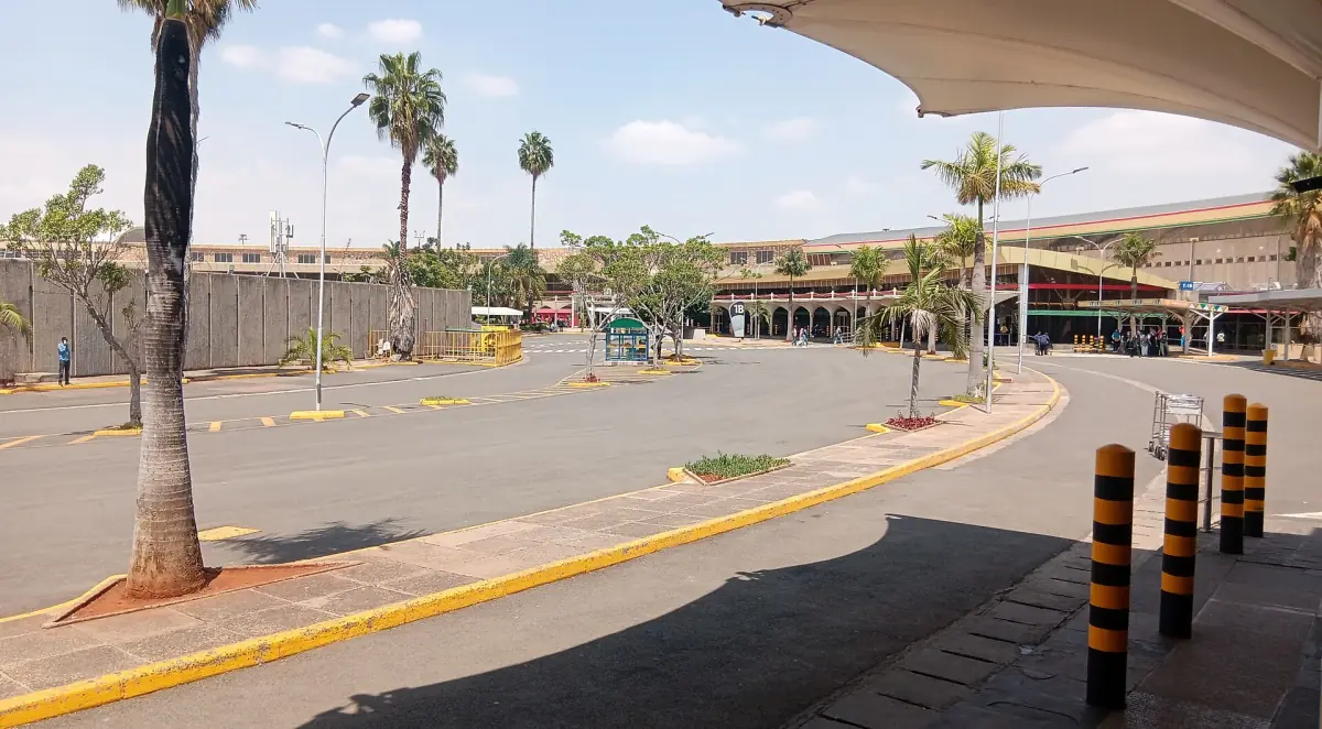 Palm-lined forecourt at the Nairobi airport terminal building in daylight